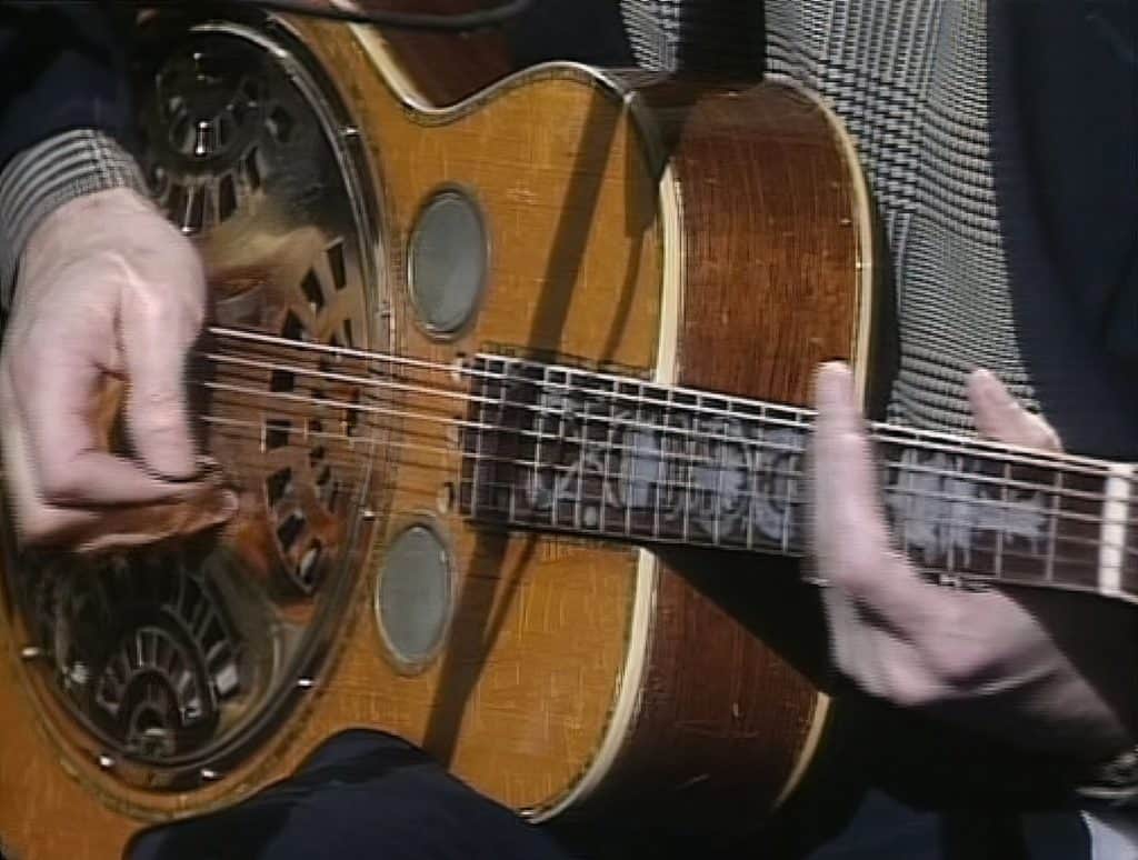 Eric Clapton playing a Dobro Resonator guitar. 