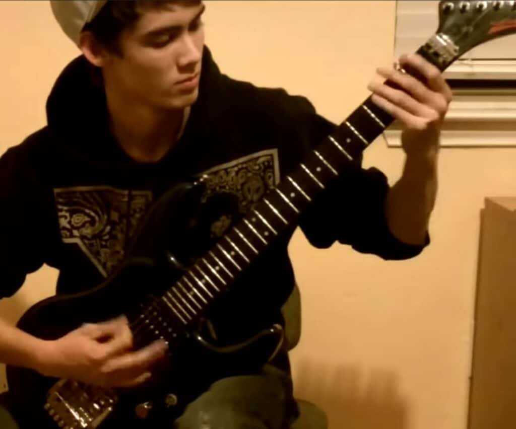 Tim playing what's most likely a Washburn guitar, 2009.