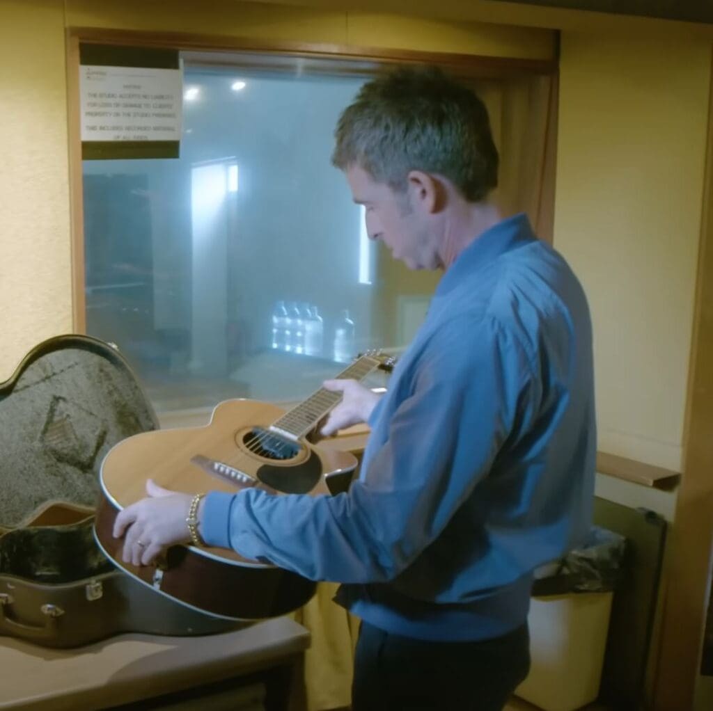 Noel at the Rockfield Studios in 2020, holding the "Wonderwall" Takamine guitar. 